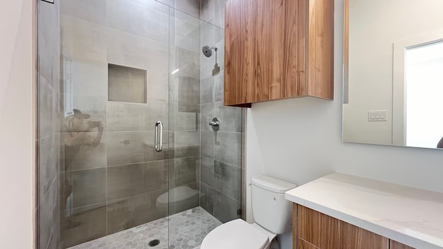 bathroom with vanity, toilet, and walk in shower