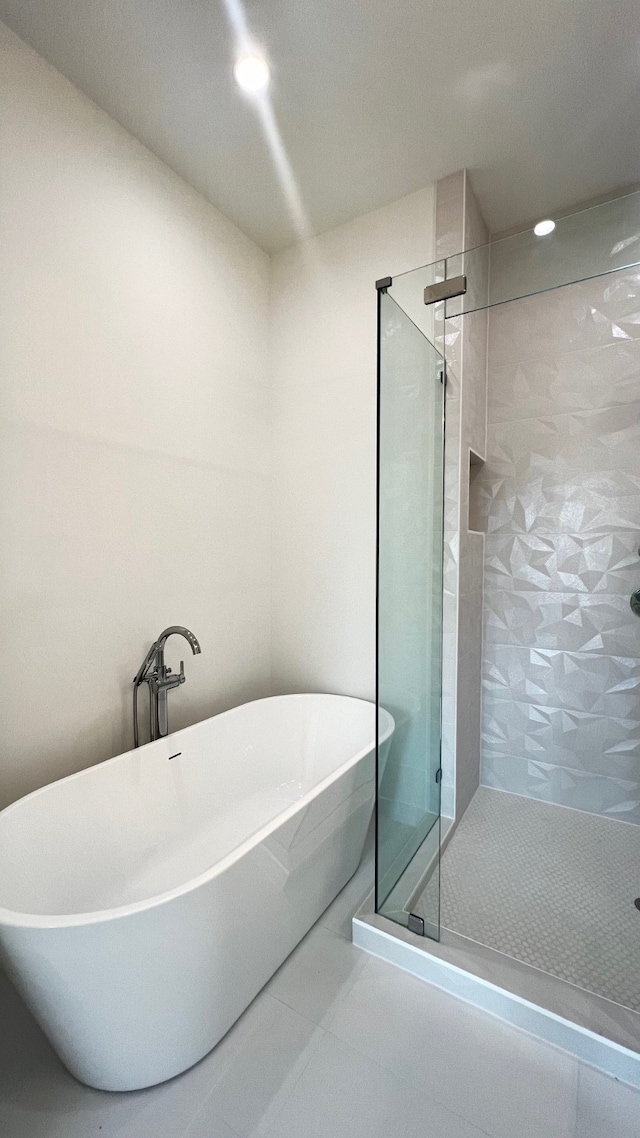 bathroom featuring plus walk in shower and tile patterned flooring