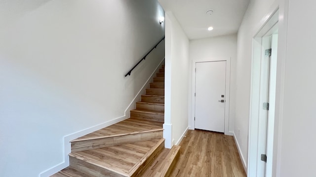 staircase with hardwood / wood-style flooring