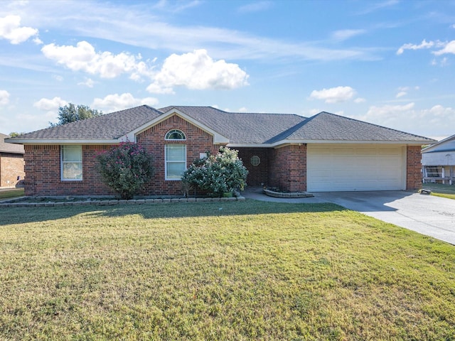 single story home with driveway, a front yard, roof with shingles, brick siding, and an attached garage