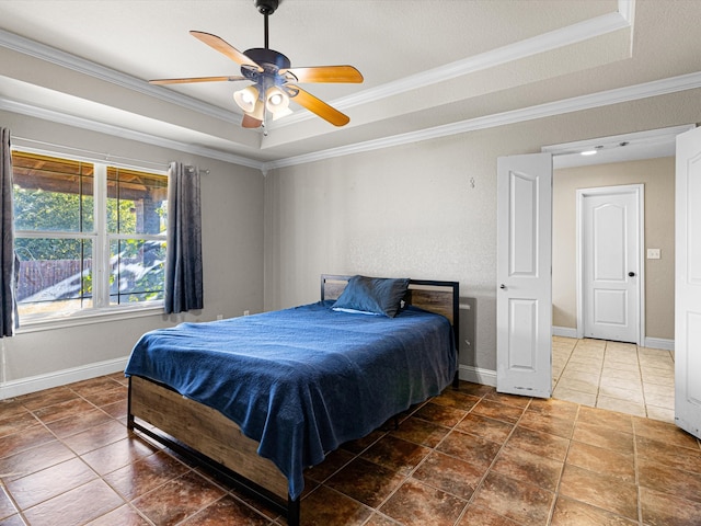 tiled bedroom with crown molding, a raised ceiling, and ceiling fan