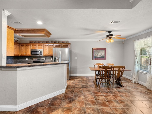 kitchen with decorative backsplash, kitchen peninsula, crown molding, appliances with stainless steel finishes, and ceiling fan