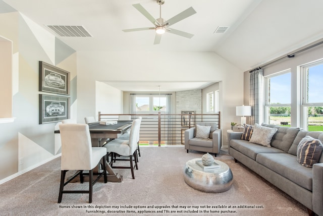 living room featuring vaulted ceiling, ceiling fan, light carpet, and plenty of natural light