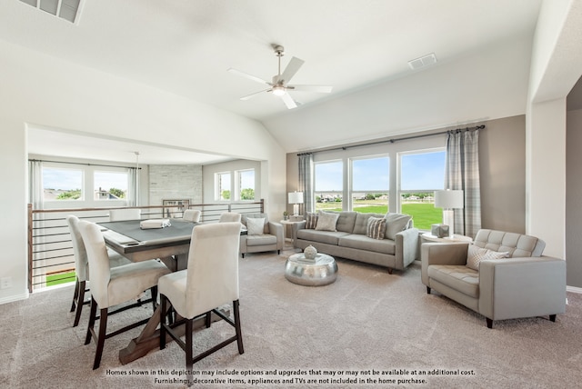 living room with ceiling fan, vaulted ceiling, and light colored carpet