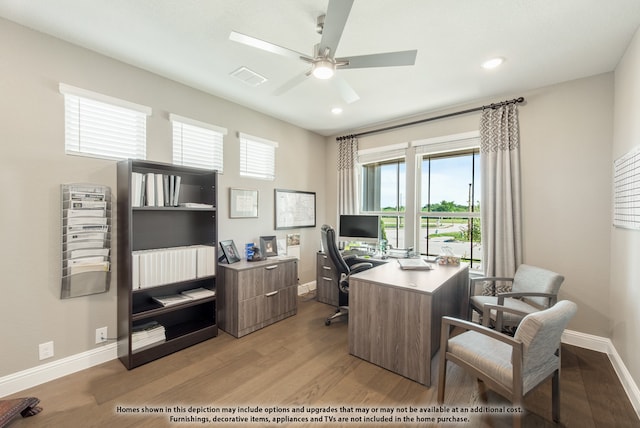 office space with light hardwood / wood-style floors and ceiling fan