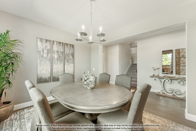 dining room with an inviting chandelier and wood-type flooring