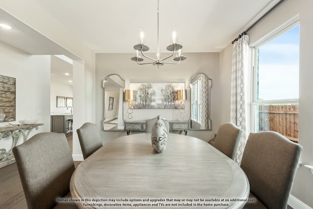 dining room with hardwood / wood-style floors and a chandelier