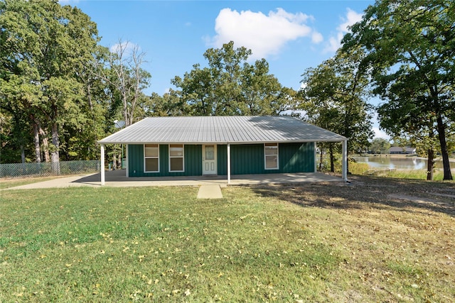 ranch-style home with a front lawn and a water view