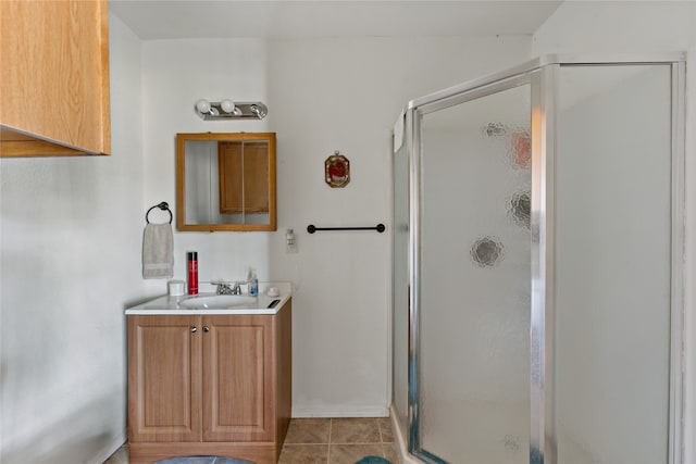 bathroom featuring vanity, a shower with shower door, and tile patterned flooring