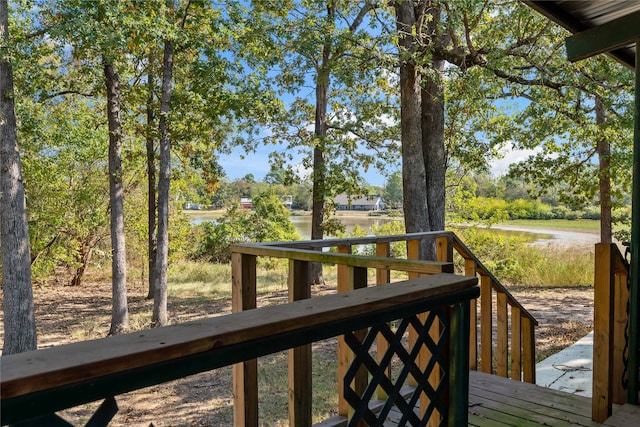 wooden terrace featuring a water view