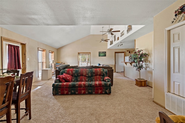 carpeted living room featuring ceiling fan, a textured ceiling, and lofted ceiling