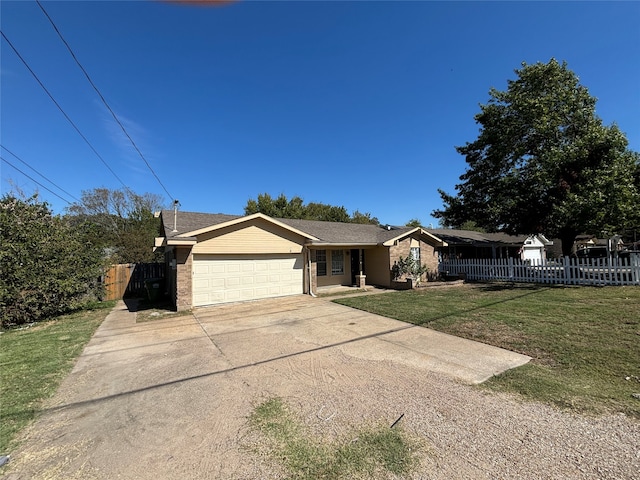 ranch-style home featuring a front lawn and a garage