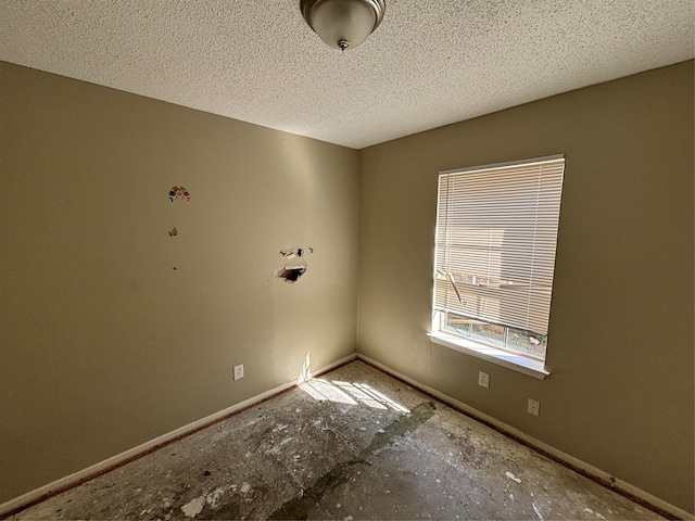 unfurnished room featuring a textured ceiling