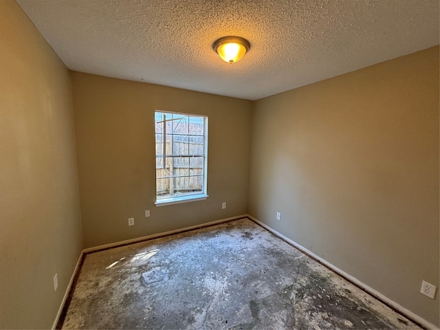 unfurnished room featuring a textured ceiling