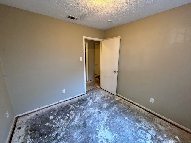 unfurnished bedroom with a textured ceiling