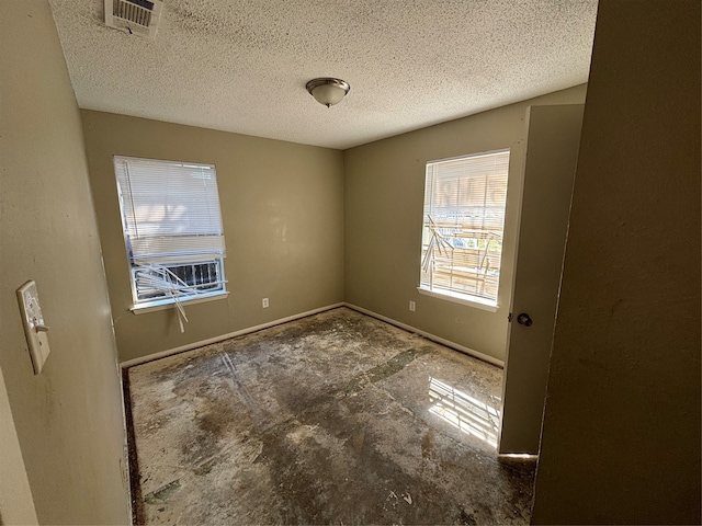 empty room with a textured ceiling