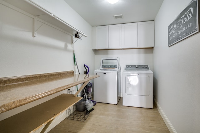 washroom with washer and dryer and light wood-type flooring