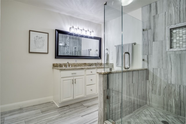 bathroom featuring vanity, a shower with shower door, and hardwood / wood-style flooring