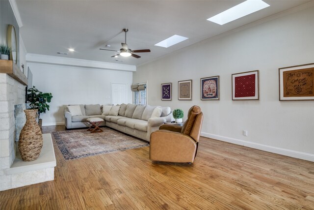 living room with crown molding, light hardwood / wood-style flooring, and ceiling fan