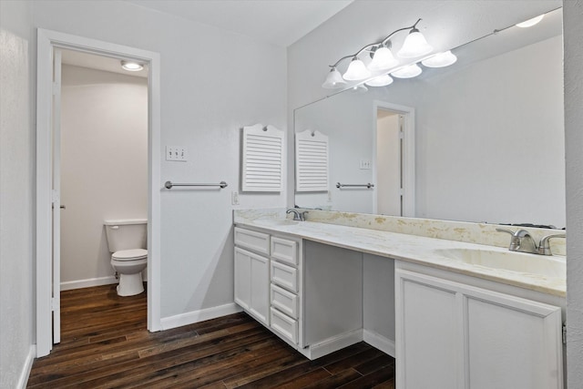 bathroom with vanity, hardwood / wood-style flooring, and toilet