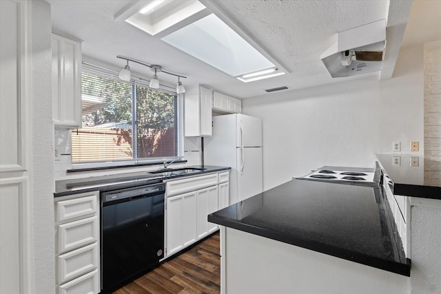 kitchen featuring a textured ceiling, white appliances, sink, dark hardwood / wood-style floors, and white cabinetry