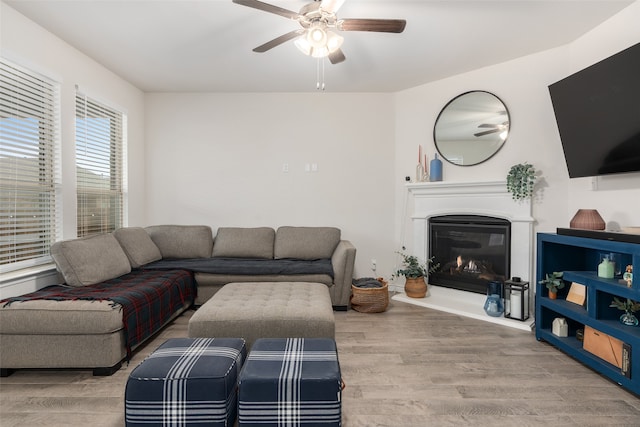 living room with light hardwood / wood-style floors and ceiling fan