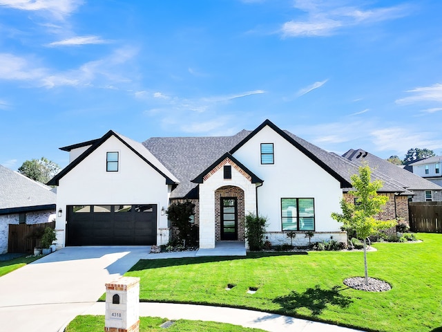 view of front of property with a front yard and a garage