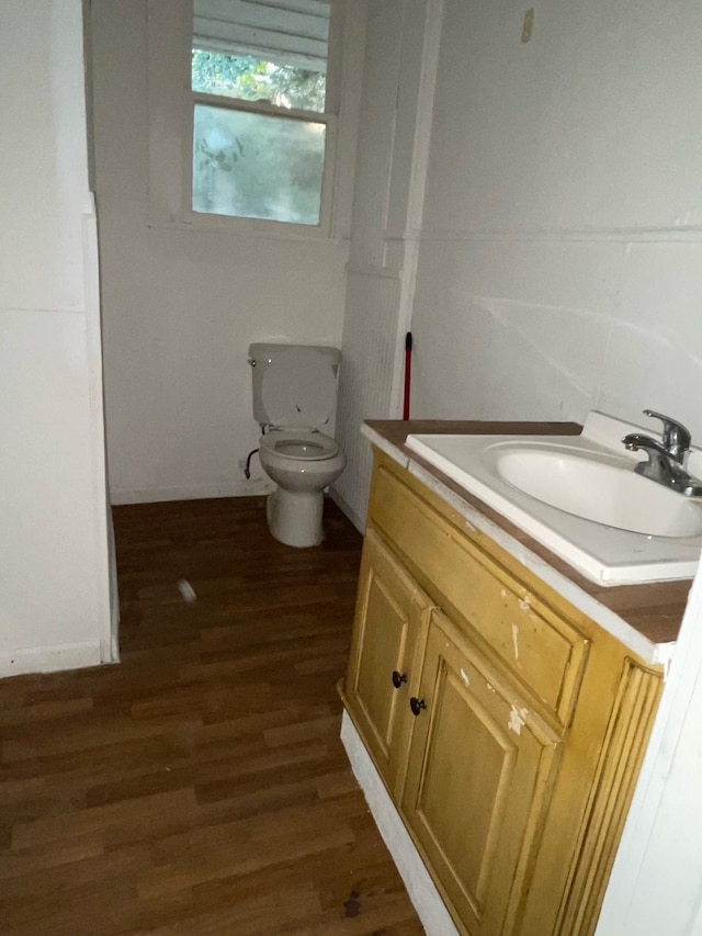 bathroom with vanity, hardwood / wood-style floors, and toilet