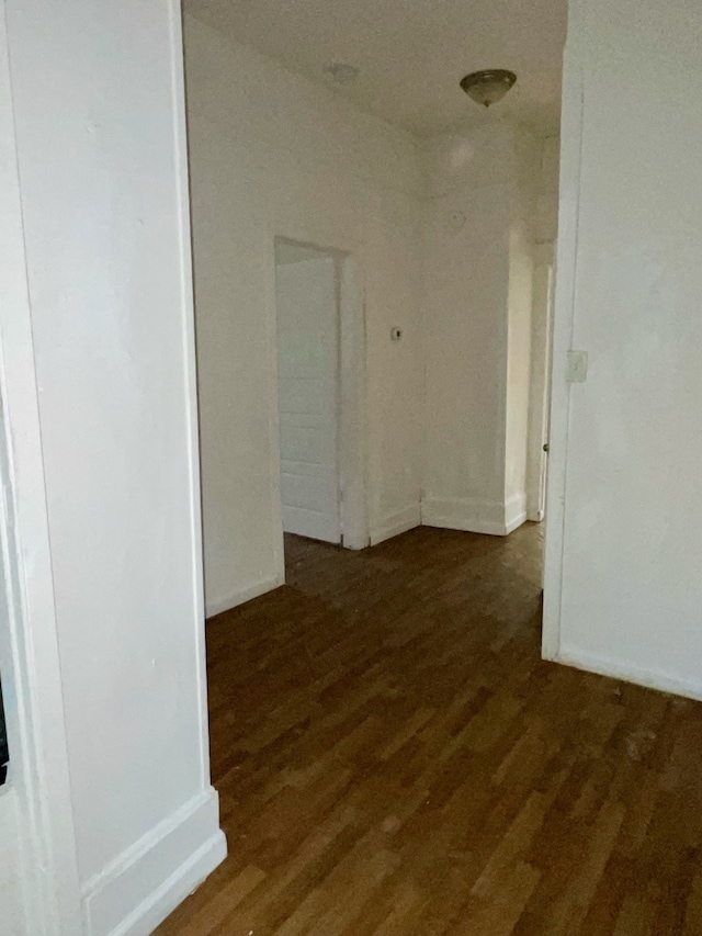 corridor with dark hardwood / wood-style floors