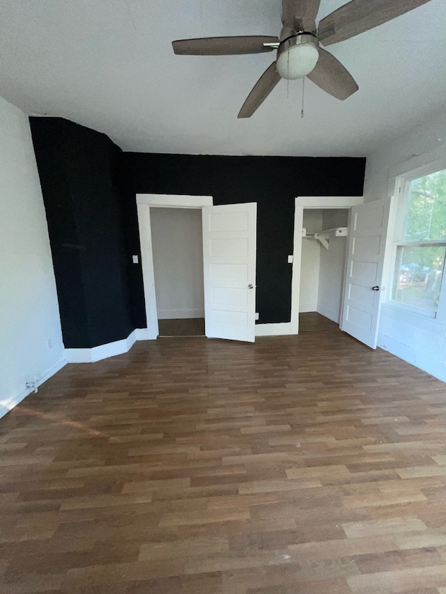 interior space with wood-type flooring and ceiling fan