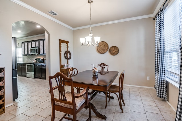 tiled dining area featuring an inviting chandelier and crown molding