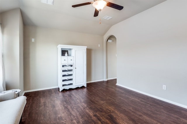 empty room with lofted ceiling, ceiling fan, and dark hardwood / wood-style flooring