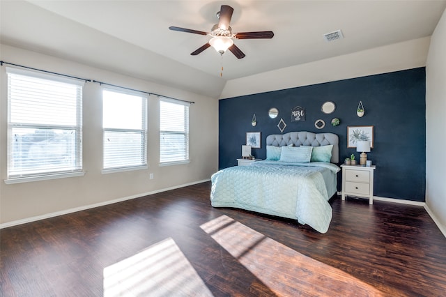 bedroom with dark wood-type flooring, vaulted ceiling, and ceiling fan