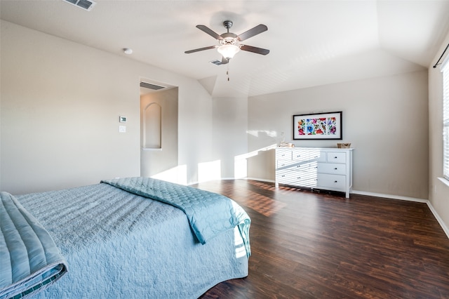 bedroom featuring dark hardwood / wood-style flooring, ceiling fan, and vaulted ceiling