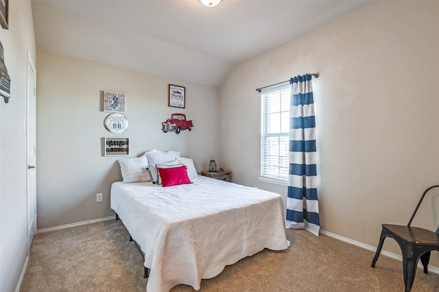 carpeted bedroom with lofted ceiling