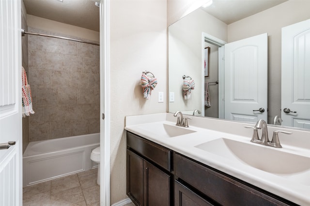 full bathroom with vanity, toilet, tiled shower / bath combo, and tile patterned flooring