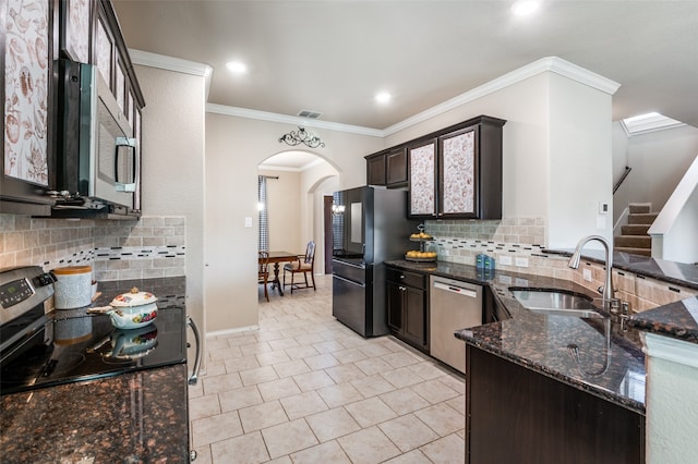 kitchen with sink, black appliances, backsplash, and dark stone countertops