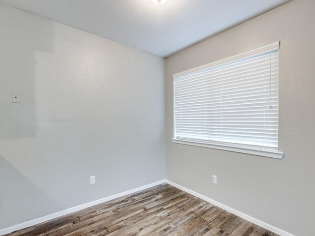 1122 Millview Dr Unit 205, Arlington, TX 76012 - unfurnished room featuring baseboards and wood finished floors