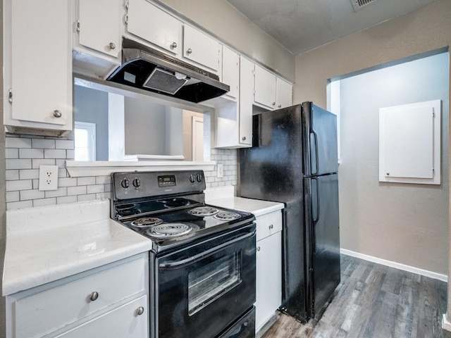1122 Millview Dr Unit 205, Arlington, TX 76012 - kitchen featuring light wood-style floors, white cabinetry, black appliances, under cabinet range hood, and light countertops