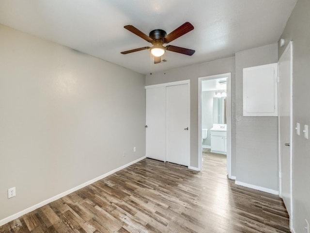 1122 Millview Dr Unit 205, Arlington, TX 76012 - unfurnished bedroom with wood finished floors, a closet, baseboards, and connected bathroom