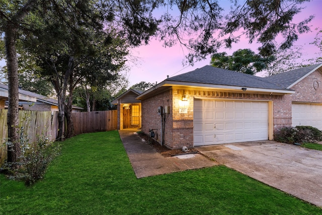 view of front of home featuring a garage and a lawn