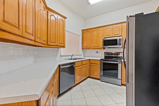 kitchen featuring sink, appliances with stainless steel finishes, backsplash, and light tile patterned floors