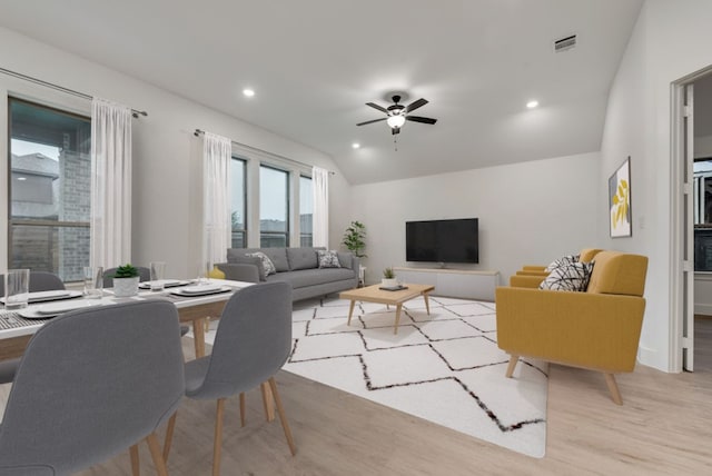 living room featuring vaulted ceiling, light wood-type flooring, and ceiling fan