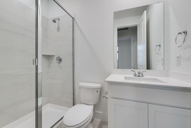 bathroom with vanity, toilet, and walk in shower