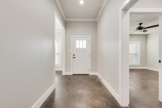 entryway featuring crown molding, ceiling fan, and plenty of natural light