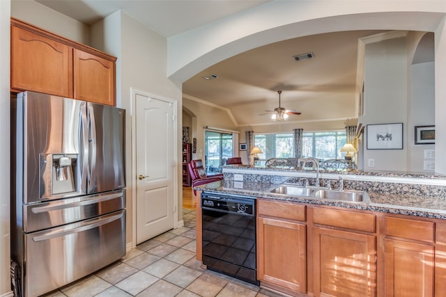 kitchen featuring black dishwasher, sink, stainless steel fridge, vaulted ceiling, and light tile patterned floors