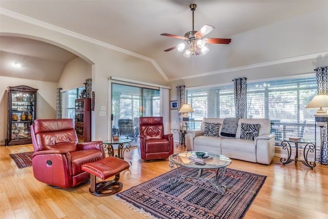 living room featuring ornamental molding, ceiling fan, wood-type flooring, and vaulted ceiling