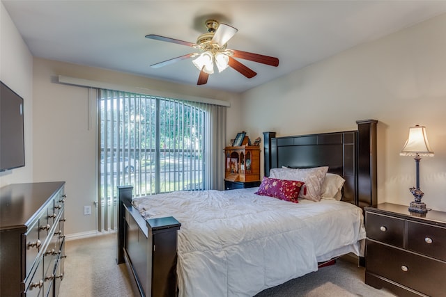 bedroom with access to exterior, light colored carpet, and ceiling fan