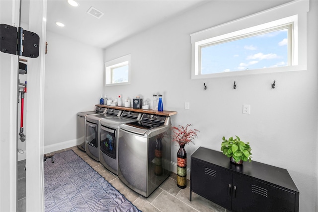 laundry area with washer and dryer and a healthy amount of sunlight