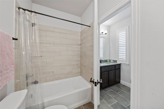 full bathroom with vanity, shower / tub combo with curtain, and toilet